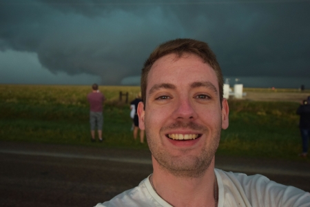 Jason looking happy with a tornado in the background