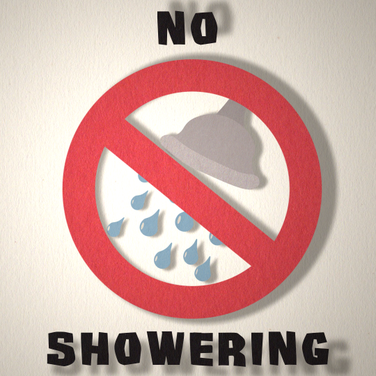 A shower head with water droplets is found in a prohibited sign with the words 