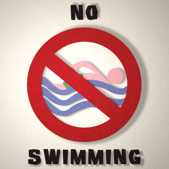 A swimmer is in a prohibited sign. The words 